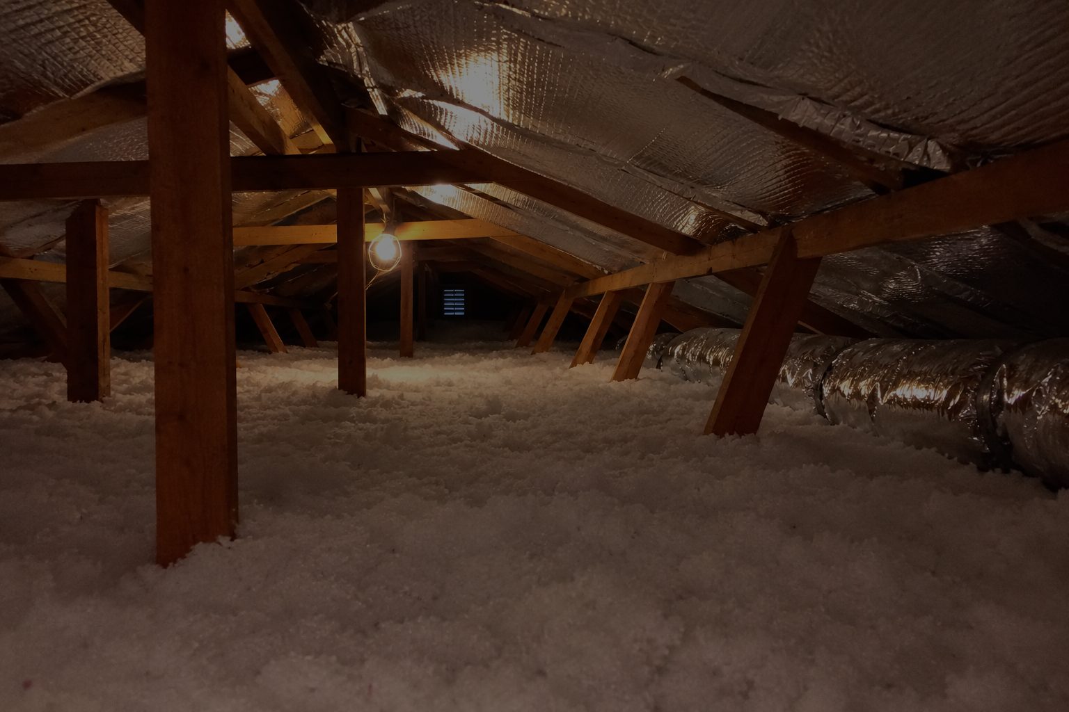 A finished attic with radiant barrier and fresh blown-in insulation