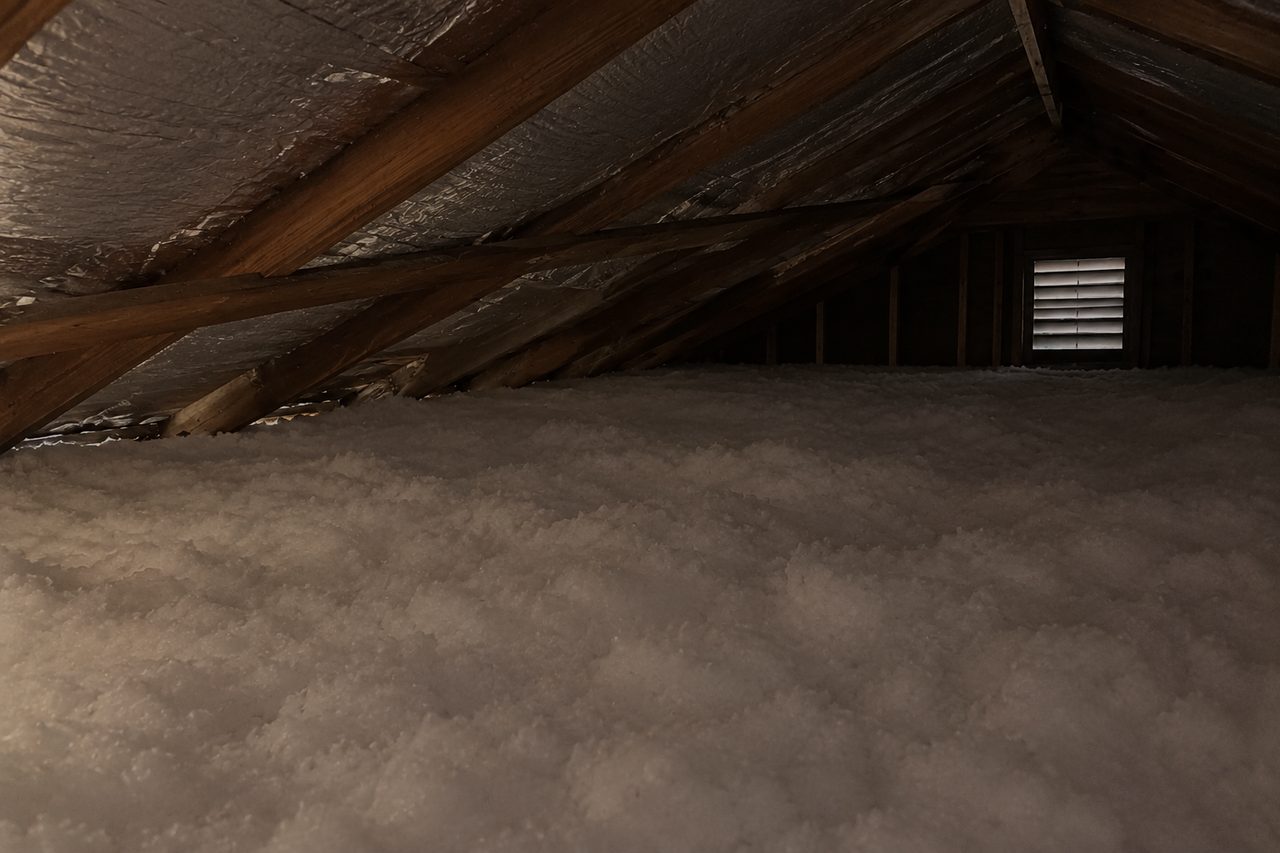The attic after: clean, deep white insulation and a radiant barrier on the roof