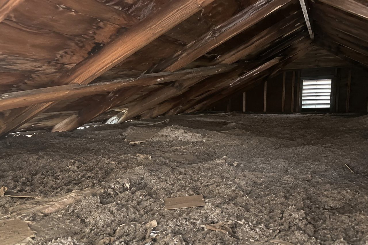 The attic before: old, dirty, flattened insulation with debris